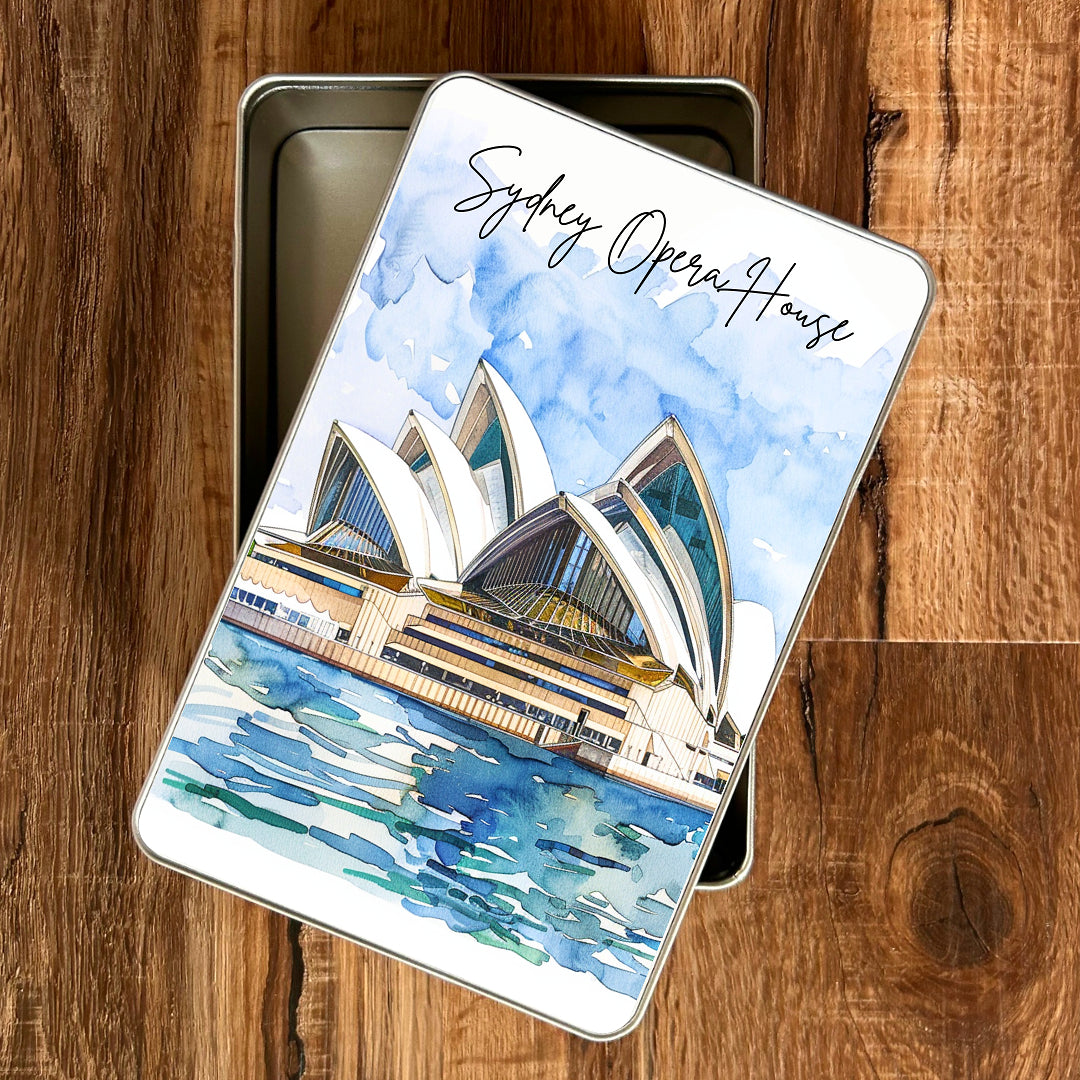 Piccola gift tin with Sydney Opera House design on a wooden surface