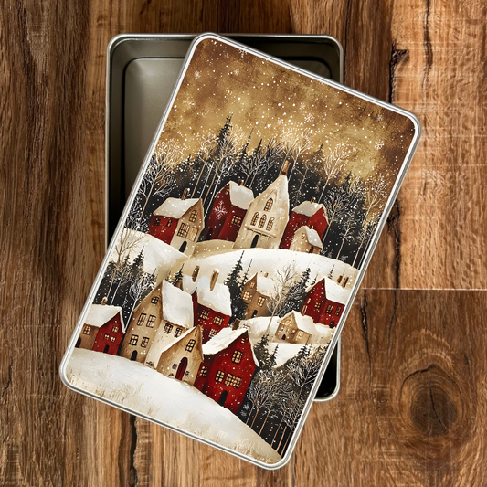 Metallic tin with a winter village design on a wooden surface