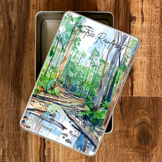 Gift tin with a Daintree rainforest design on a wooden surface