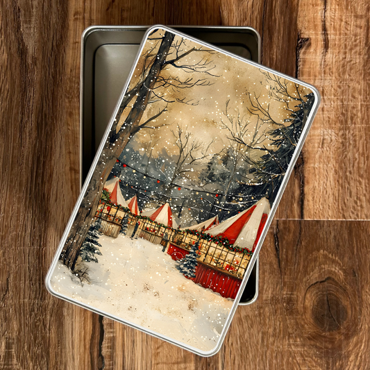 Decorative tin with a winter scene design on a wooden surface