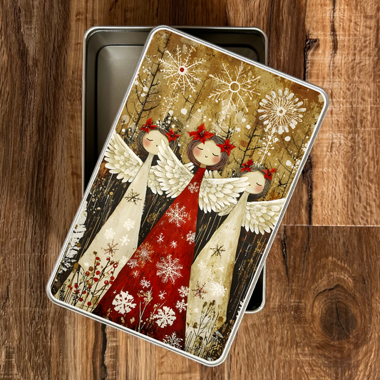 Decorative tin with angel design on a wooden surface