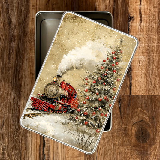 Decorative tin with a Christmas train and tree design on a wooden surface