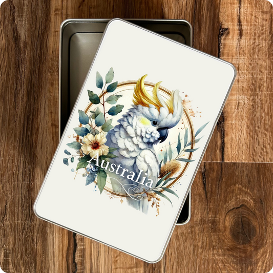 Metal tin with a cockatoo design and 'Australia' text on a wooden surface