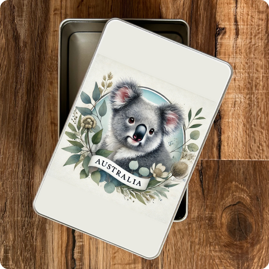 Metallic tin with a koala illustration and 'Australia' text on a wooden surface